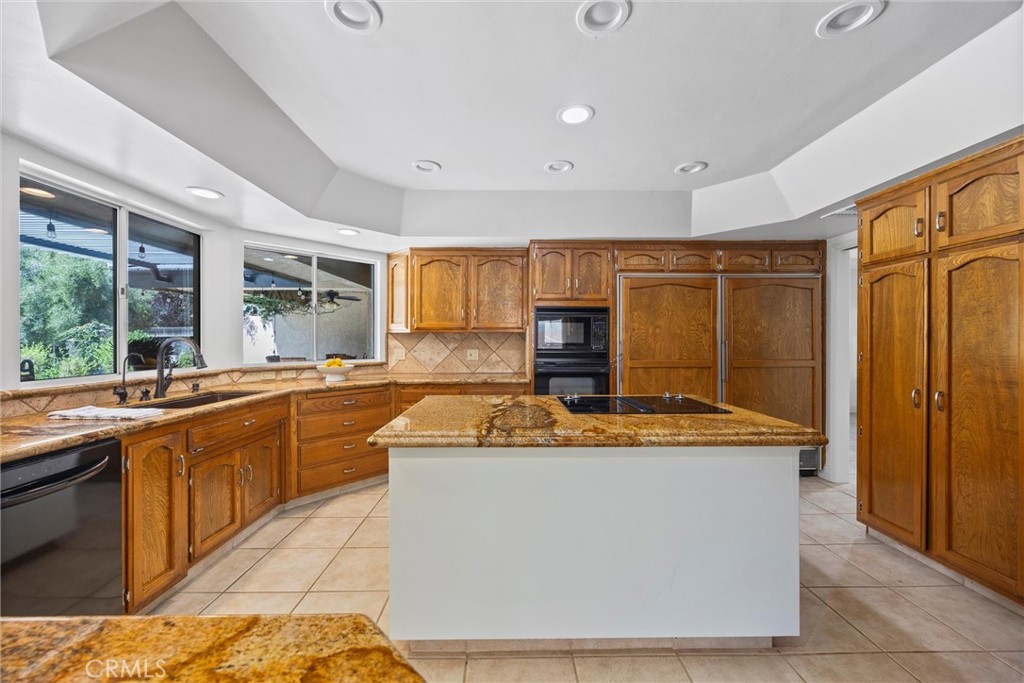 11717 Old Town Road Bakersfield, CA 93312 - Photo 28 of 61 a dining hall with stainless steel appliances granite countertop furniture a sink a counter space and a window