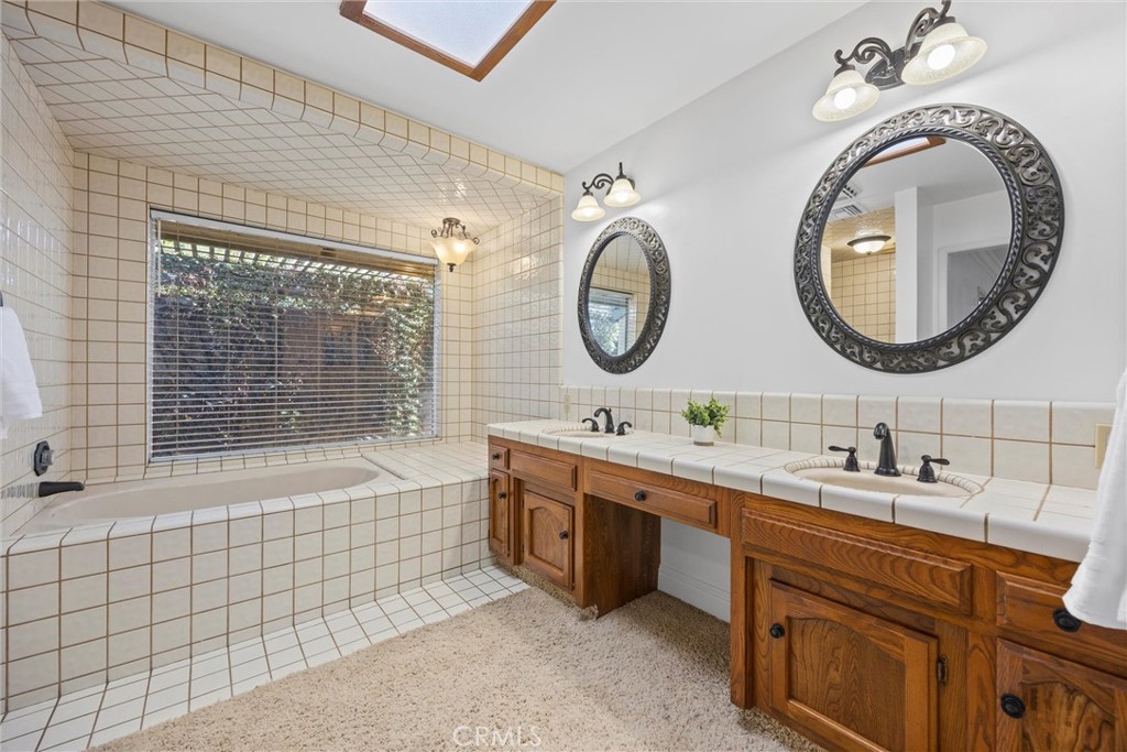 11717 Old Town Road Bakersfield, CA 93312 - Photo 35 of 61 a bathroom with a double vanity sink mirror and bathtub