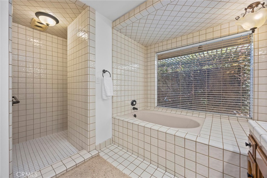 11717 Old Town Road Bakersfield, CA 93312 - Photo 36 of 61 a bathroom with a bathtub and shower