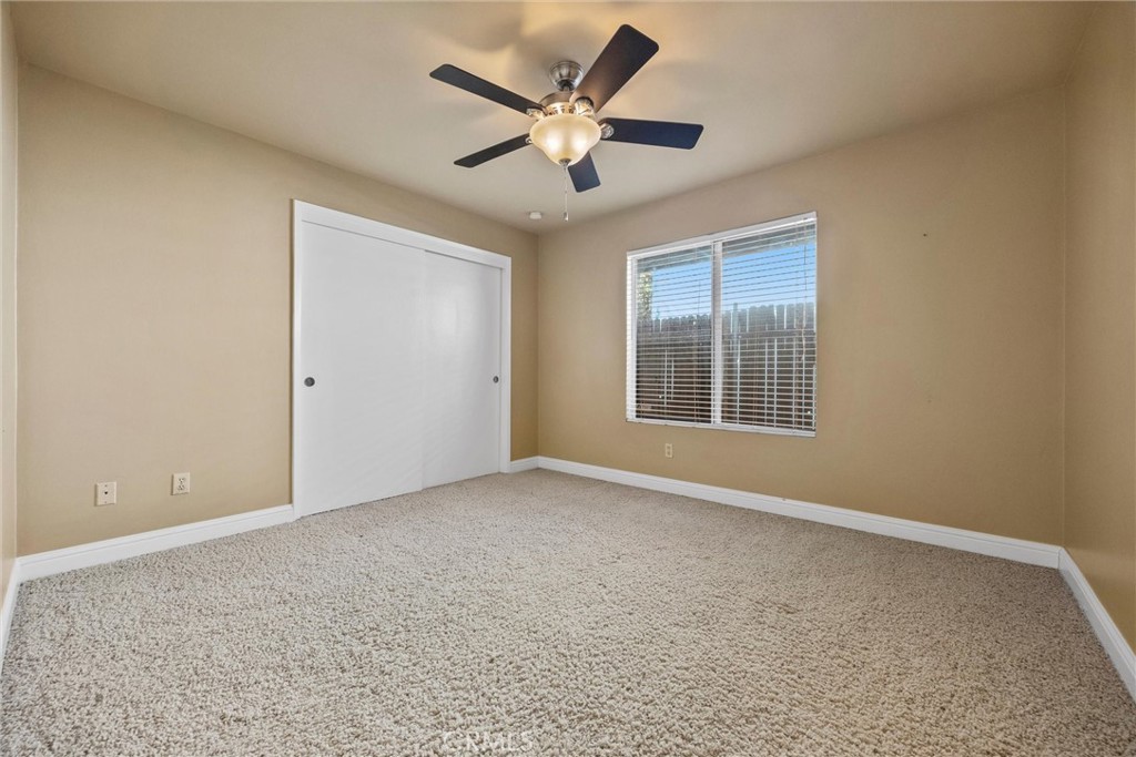 11717 Old Town Road Bakersfield, CA 93312 - Photo 40 of 61 an empty room with ceiling fan and windows