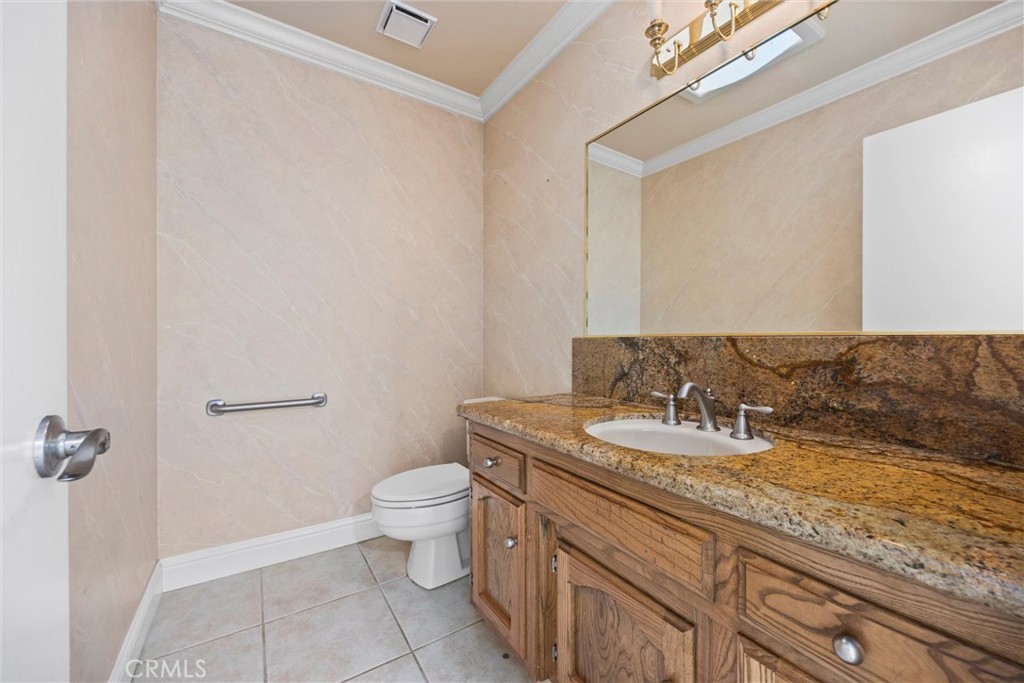 11717 Old Town Road Bakersfield, CA 93312 - Photo 42 of 61 a bathroom with a granite countertop sink a toilet and a mirror
