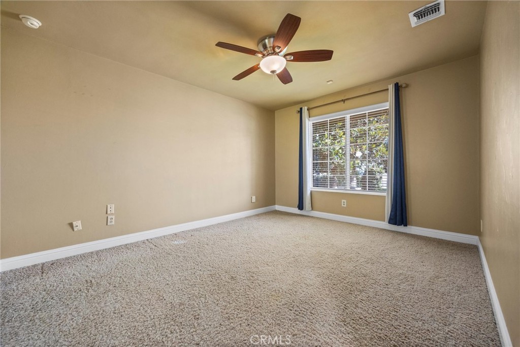 11717 Old Town Road Bakersfield, CA 93312 - Photo 43 of 61 an empty room with ceiling fan and windows