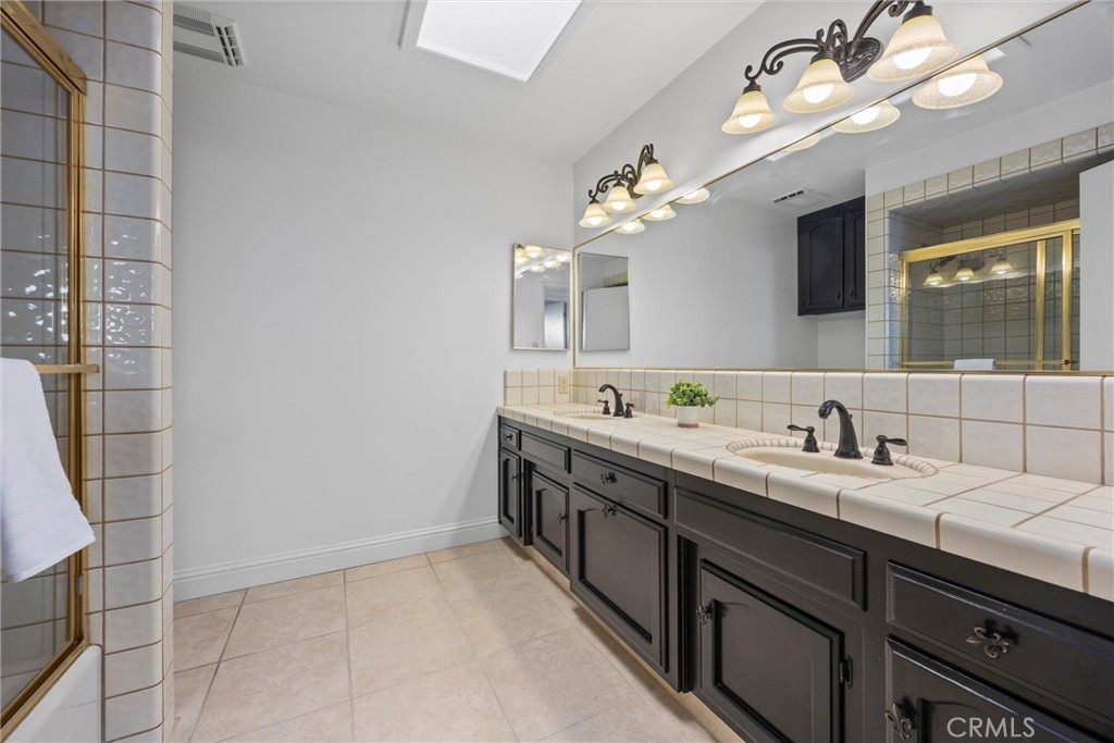 11717 Old Town Road Bakersfield, CA 93312 - Photo 45 of 61 a spacious bathroom with a double vanity sink and a mirror