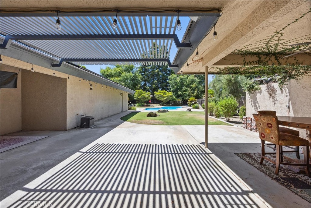11717 Old Town Road Bakersfield, CA 93312 - Photo 50 of 61 a view of a patio with table and chairs with wooden floor and fence