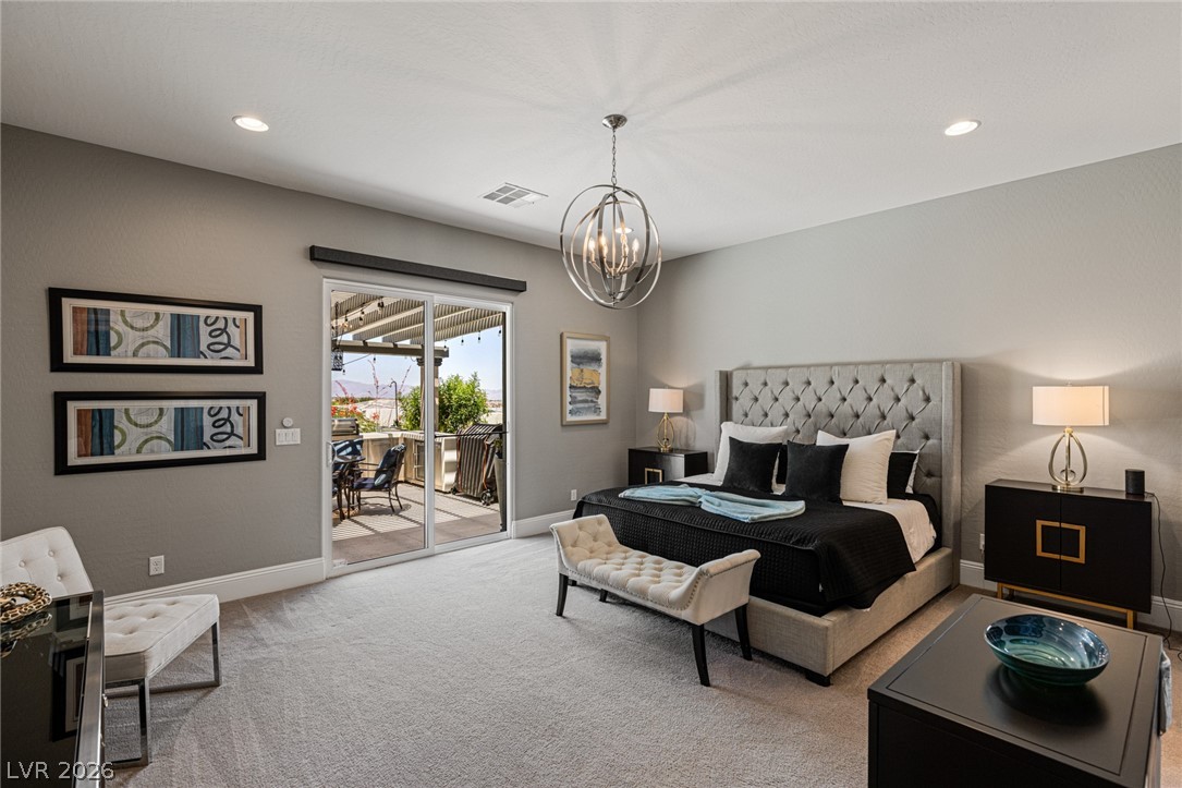 10118 Copper Edge Road Las Vegas, NV 89148 - Photo 18 of 48 Step into this spacious primary suite, offering direct access to an outdoor patio, perfect for enjoying scenic views.