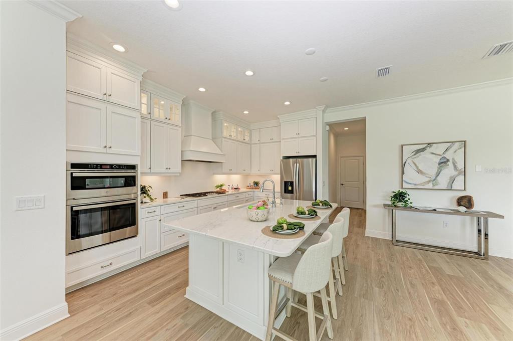 14359 Skipping Stone Loop Parrish, FL 34219 - Photo 13 of 71 a kitchen with white cabinets and stainless steel appliances