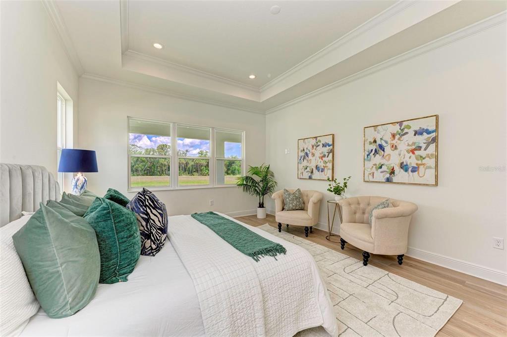 14359 Skipping Stone Loop Parrish, FL 34219 - Photo 23 of 71 a spacious bedroom with a bed a couch and a window