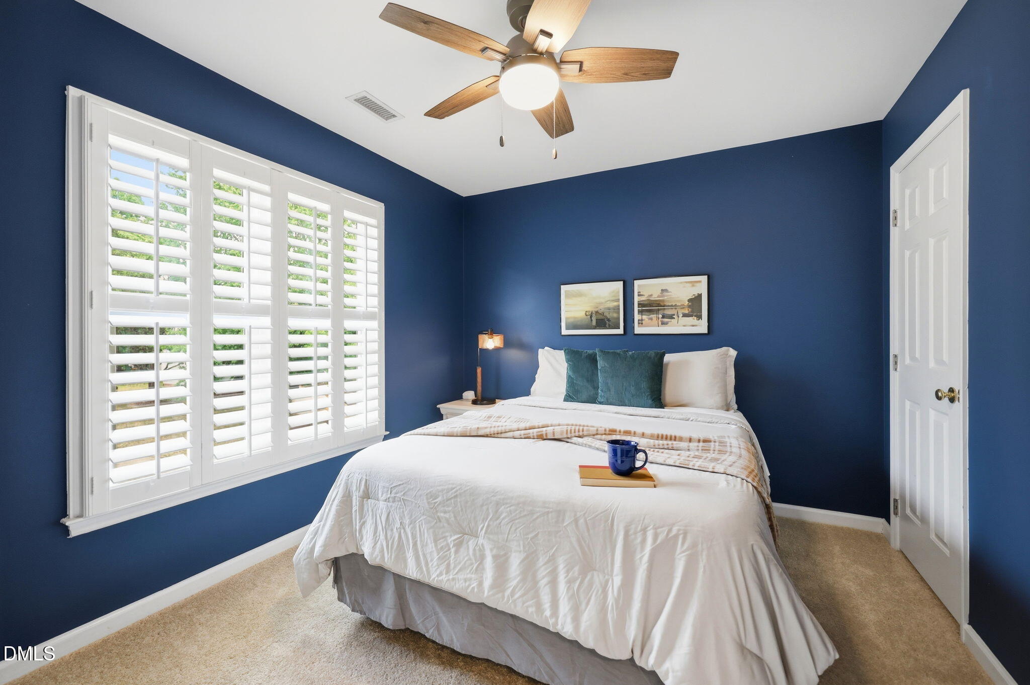 1716 Farmington Grove Drive Raleigh, NC 27614 - Photo 28 of 41 a bedroom with a large bed and a chandelier