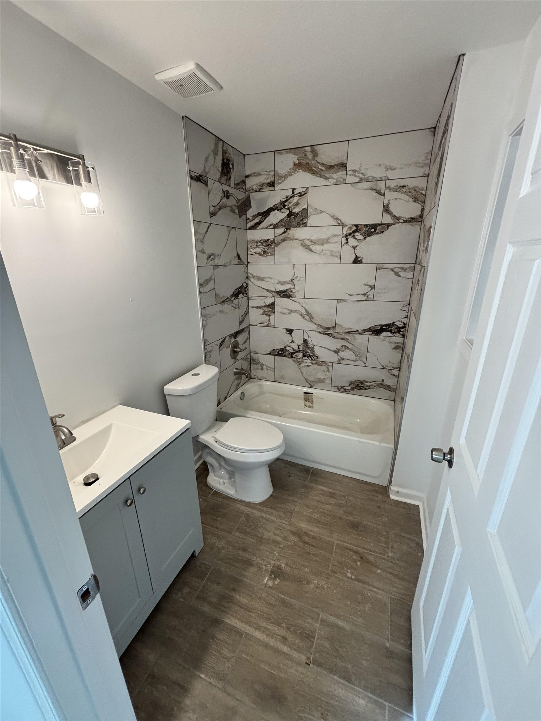 589 Gilleas Road Memphis, TN 38109 - Photo 5 of 6 a bathroom with a toilet and a shower curtain