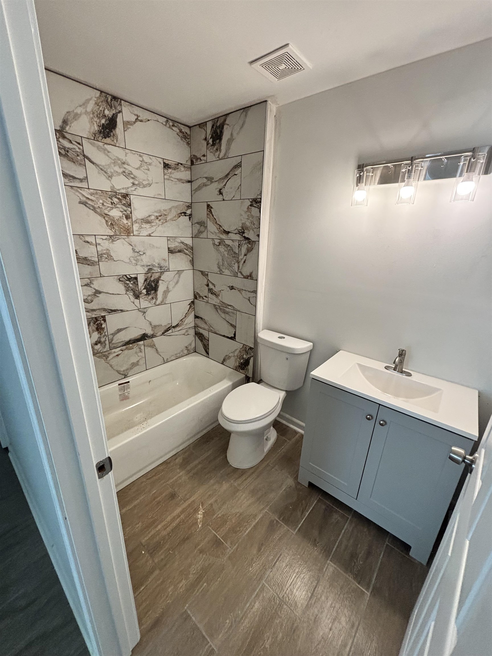 589 Gilleas Road Memphis, TN 38109 - Photo 6 of 6 a bathroom with a bathtub shower sink mirror and toilet