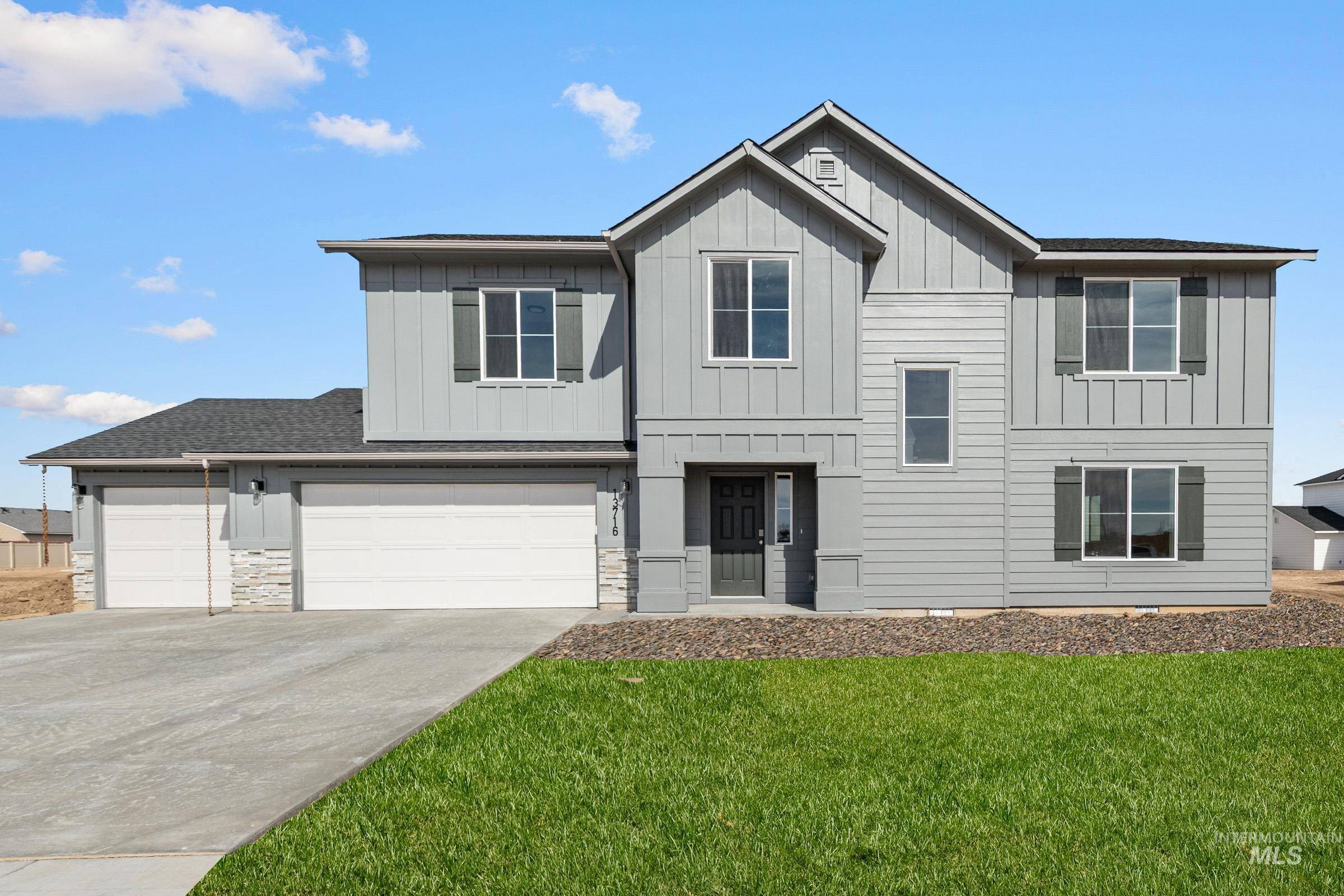 13716 Redway Court Caldwell, ID 83607 - Photo 1 of 18 View of front of home featuring board and batten siding, driveway, a front lawn, and roof with shingles