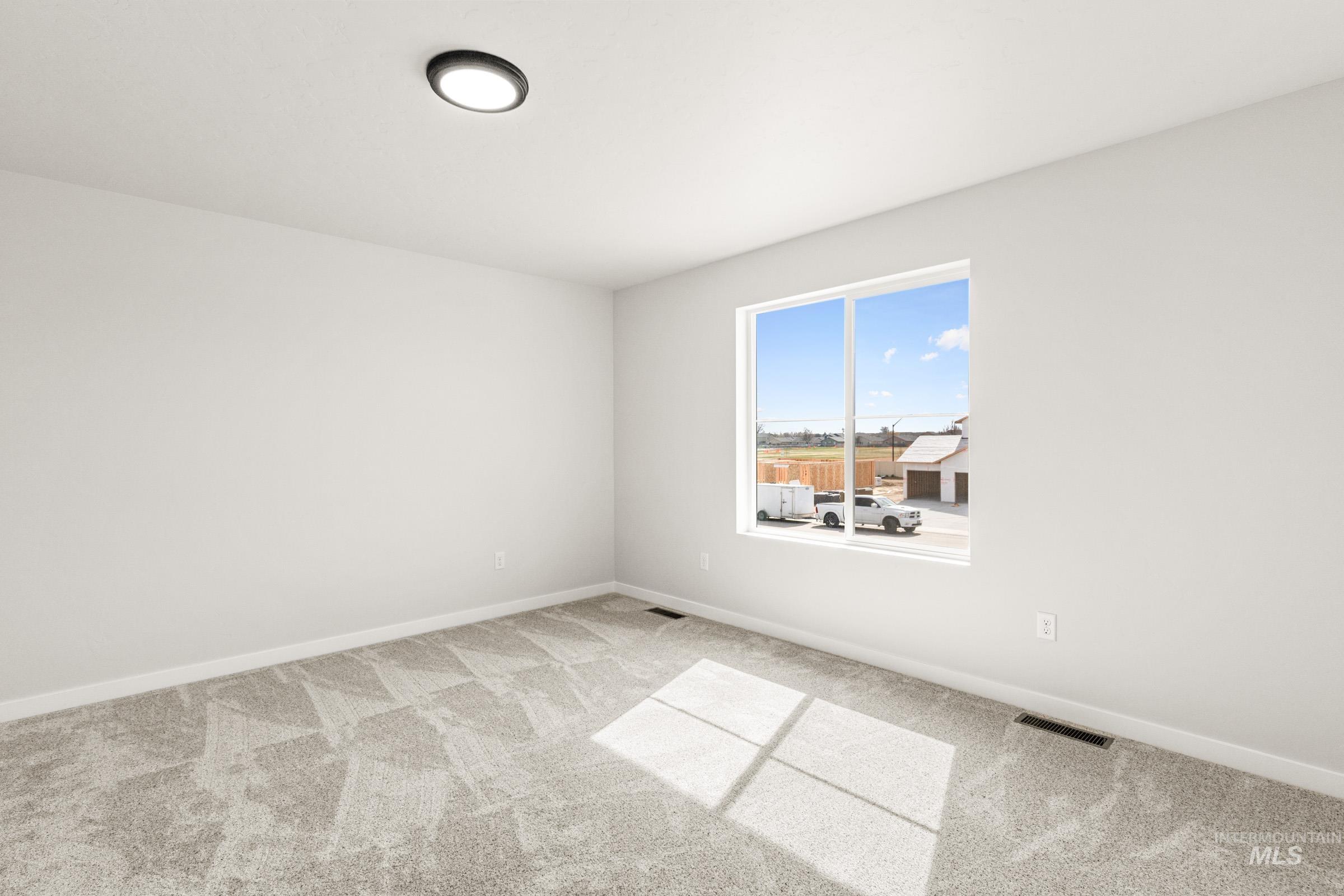 13716 Redway Court Caldwell, ID 83607 - Photo 9 of 18 Empty room featuring light colored carpet and baseboards