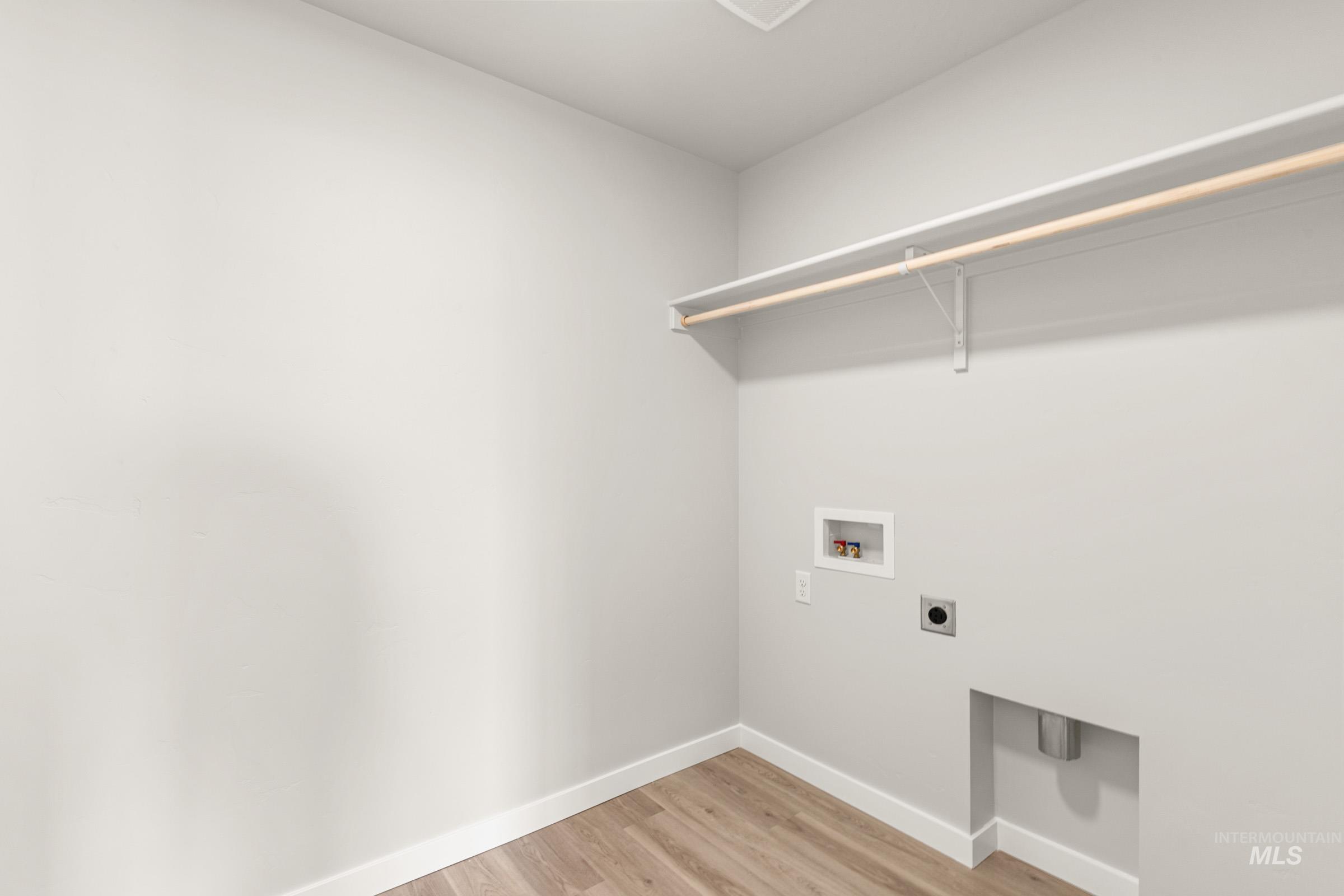 13716 Redway Court Caldwell, ID 83607 - Photo 12 of 18 Laundry area featuring light wood finished floors, hookup for an electric dryer, and hookup for a washing machine