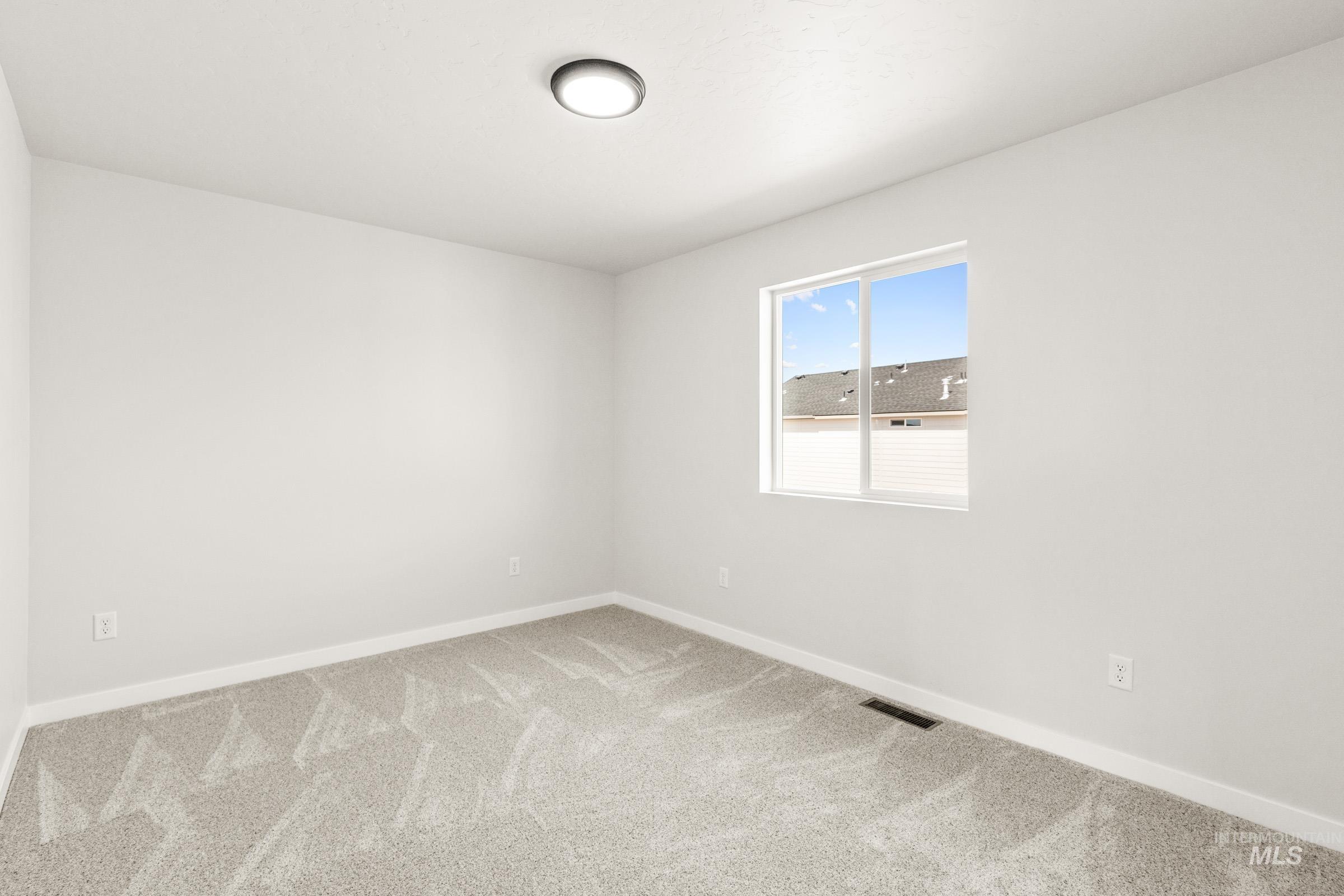13716 Redway Court Caldwell, ID 83607 - Photo 15 of 18 Spare room featuring baseboards and light carpet