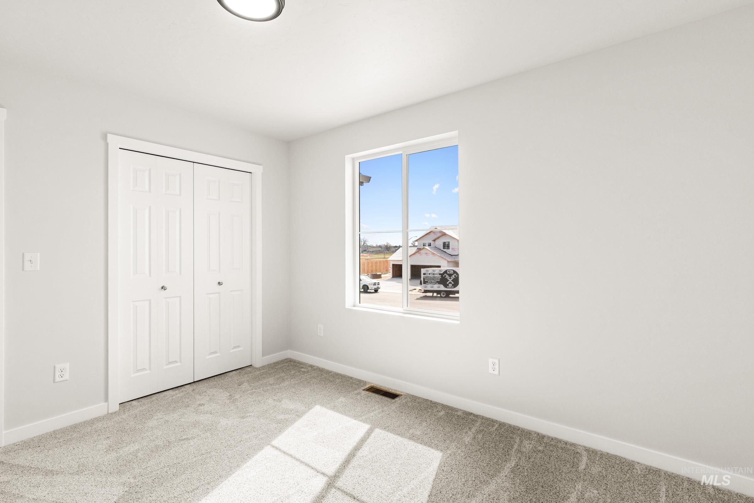 13716 Redway Court Caldwell, ID 83607 - Photo 16 of 18 Unfurnished bedroom with a closet and light colored carpet