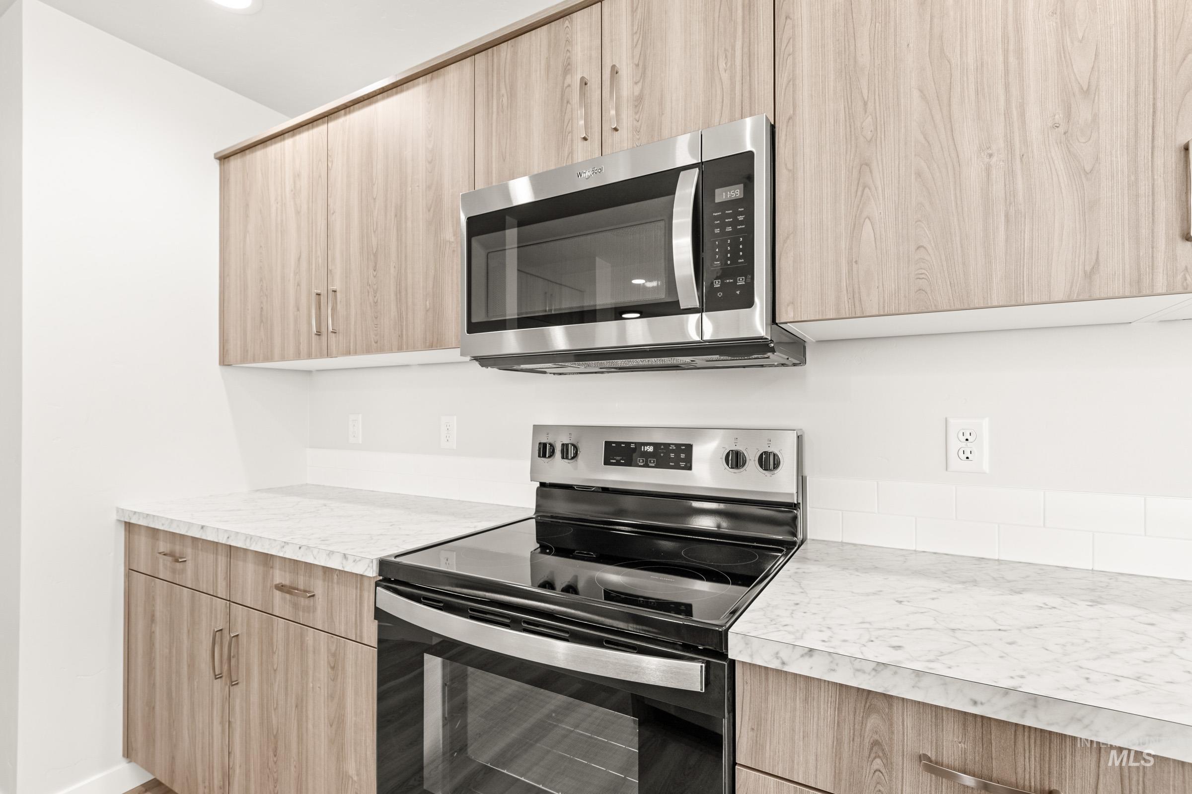13716 Redway Court Caldwell, ID 83607 - Photo 7 of 18 Kitchen featuring stainless steel appliances, light wood finish cabinetry, light countertops, and modern cabinets