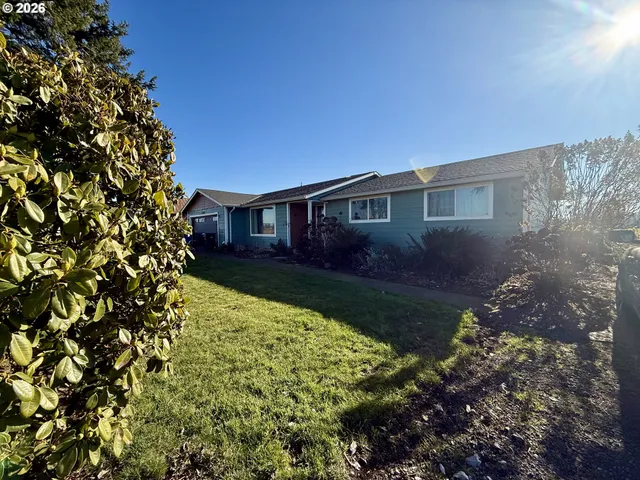 a kitchen with stainless steel appliances granite countertop a refrigerator a sink dishwasher a stove and a refrigerator with wooden floor