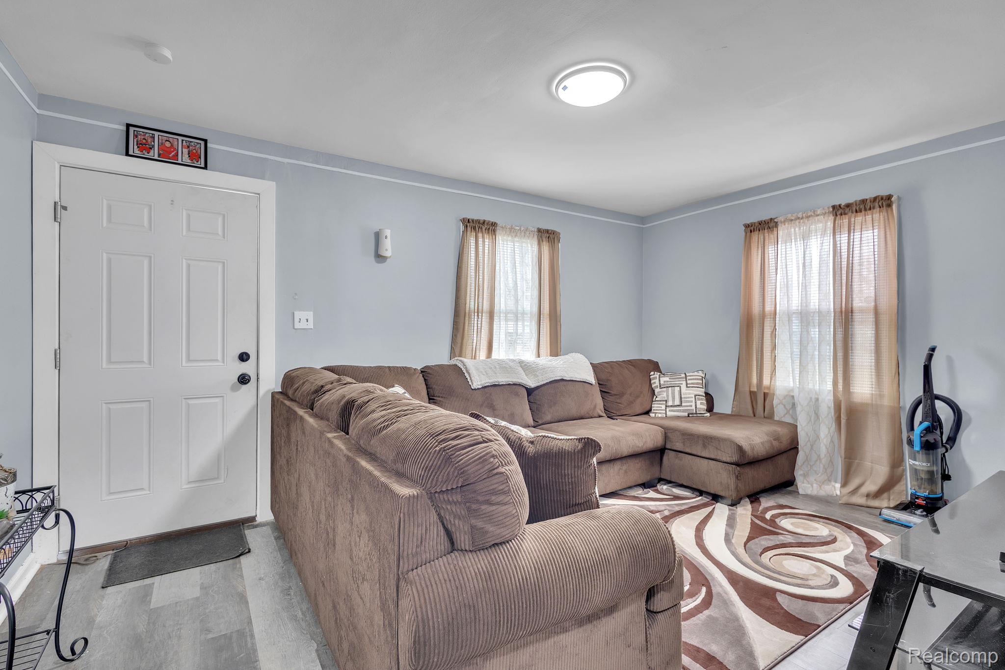 8401 Fielding Street Detroit, MI 48228 - Photo 5 of 34 Living area with plenty of natural light and wood finished floors