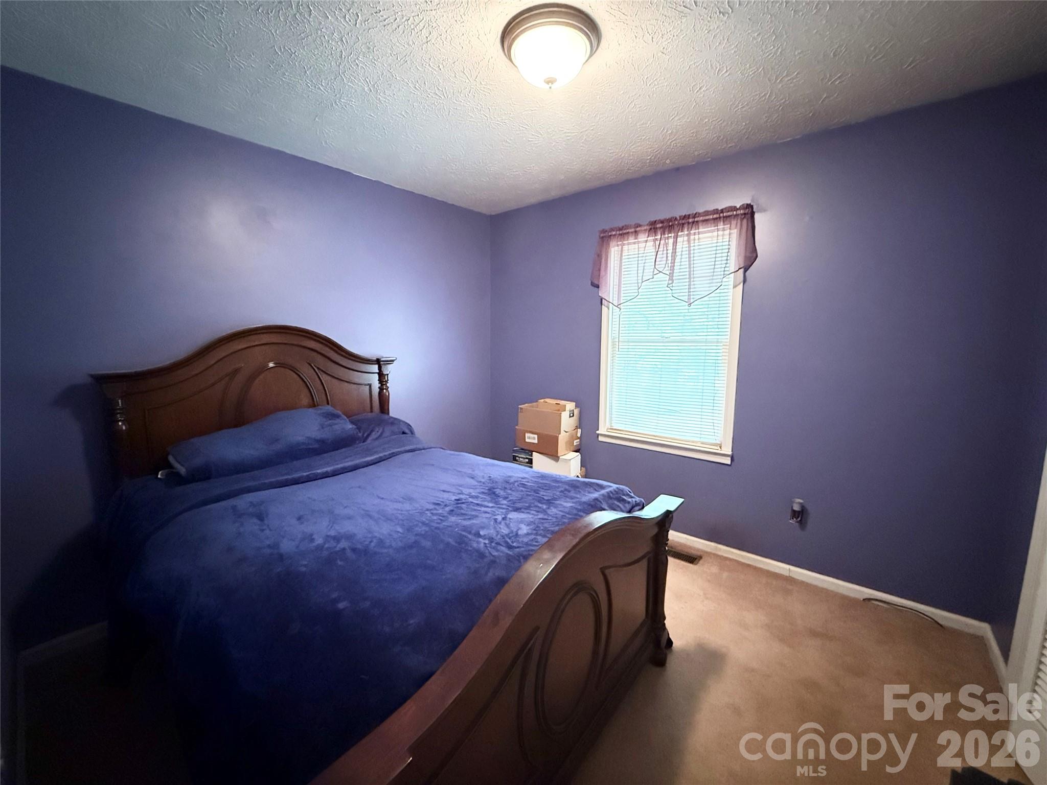 580 Legion Road Lenoir, NC 28645 - Photo 14 of 22 a bedroom with a bed and window