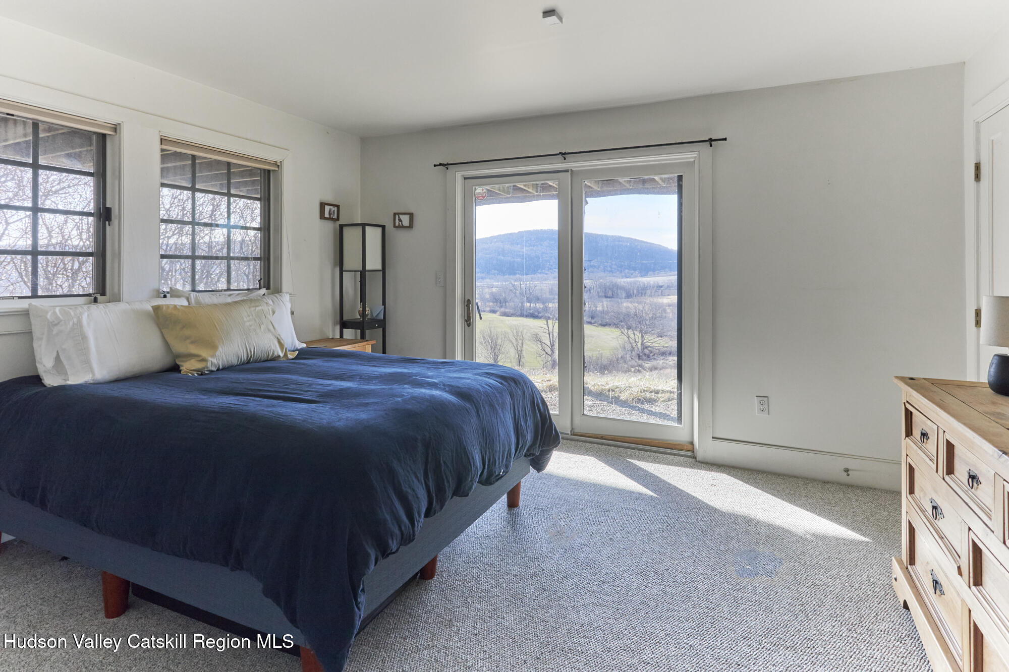 87 Kaye Road Millerton, NY 12546 - Photo 32 of 46 a spacious bedroom with a large bed and a large window