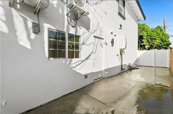 a house with a large window and potted plants