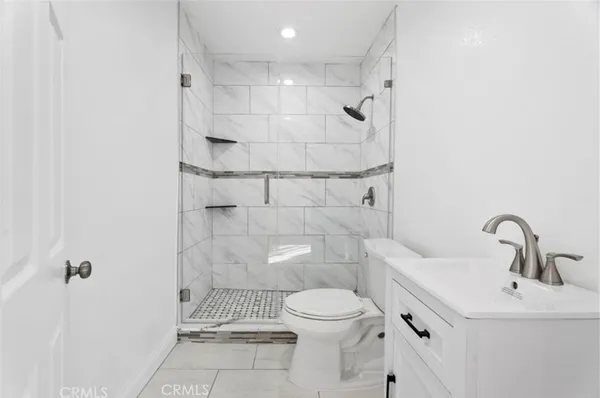 a bathroom with a toilet sink and shower