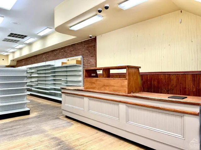 a view of living room with furniture and wooden floor