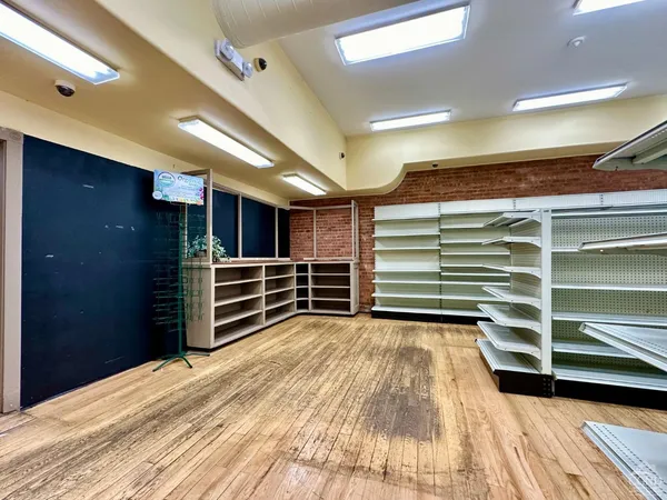 a view of empty room with wooden floor and closet