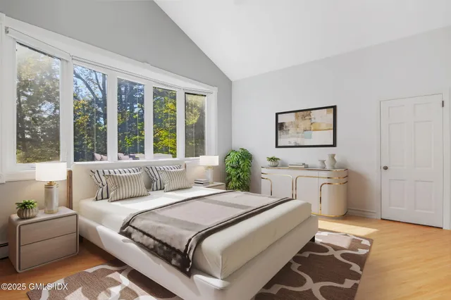 a spacious bedroom with a large bed and a window