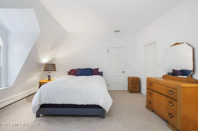 a bedroom with a bed and cabinets