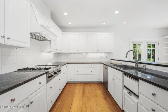 a kitchen with a sink stove and cabinets