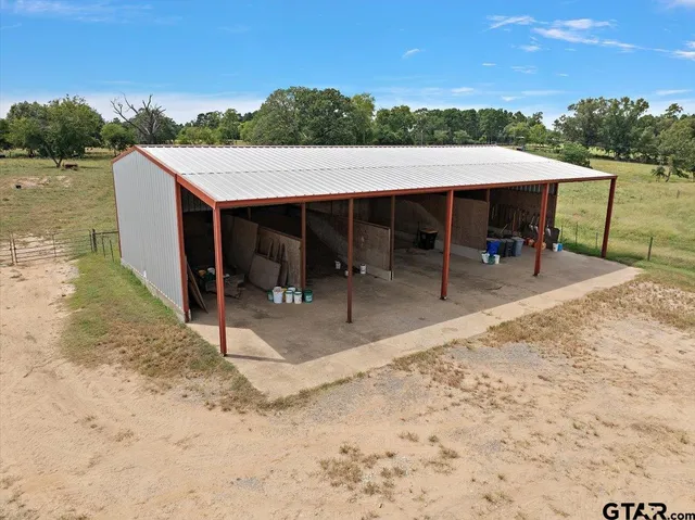 a view of a patio with table and chairs with wooden floor and fence