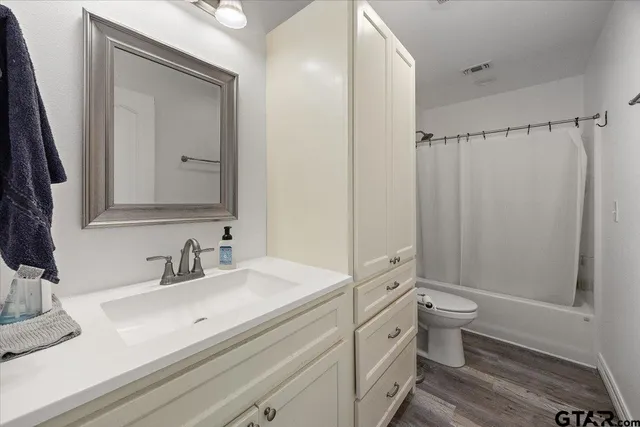 a bathroom with a double vanity sink toilet and shower