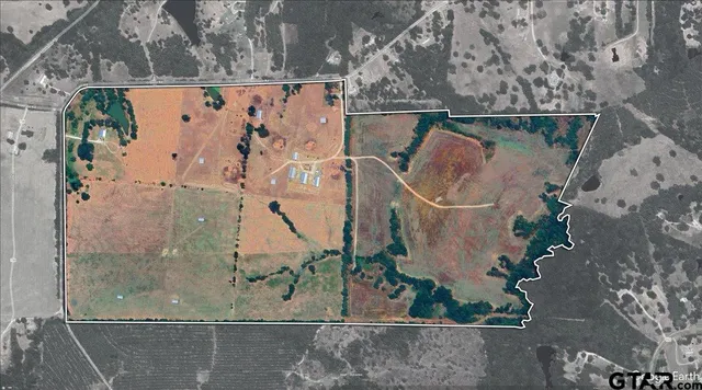 a view of a field with wooden fence
