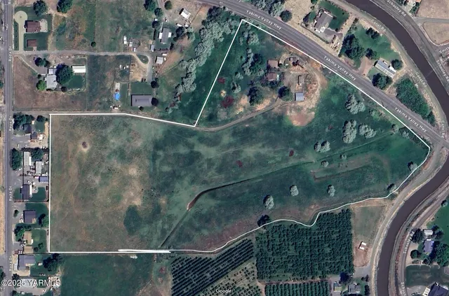 an aerial view of a residential houses with outdoor space