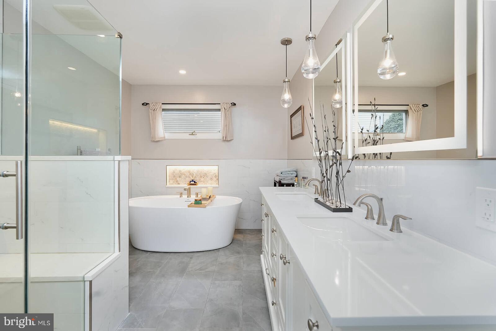 9505 Columbia Boulevard Silver Spring, MD 20910 - Photo 17 of 55 a bathroom with a tub sink and mirror
