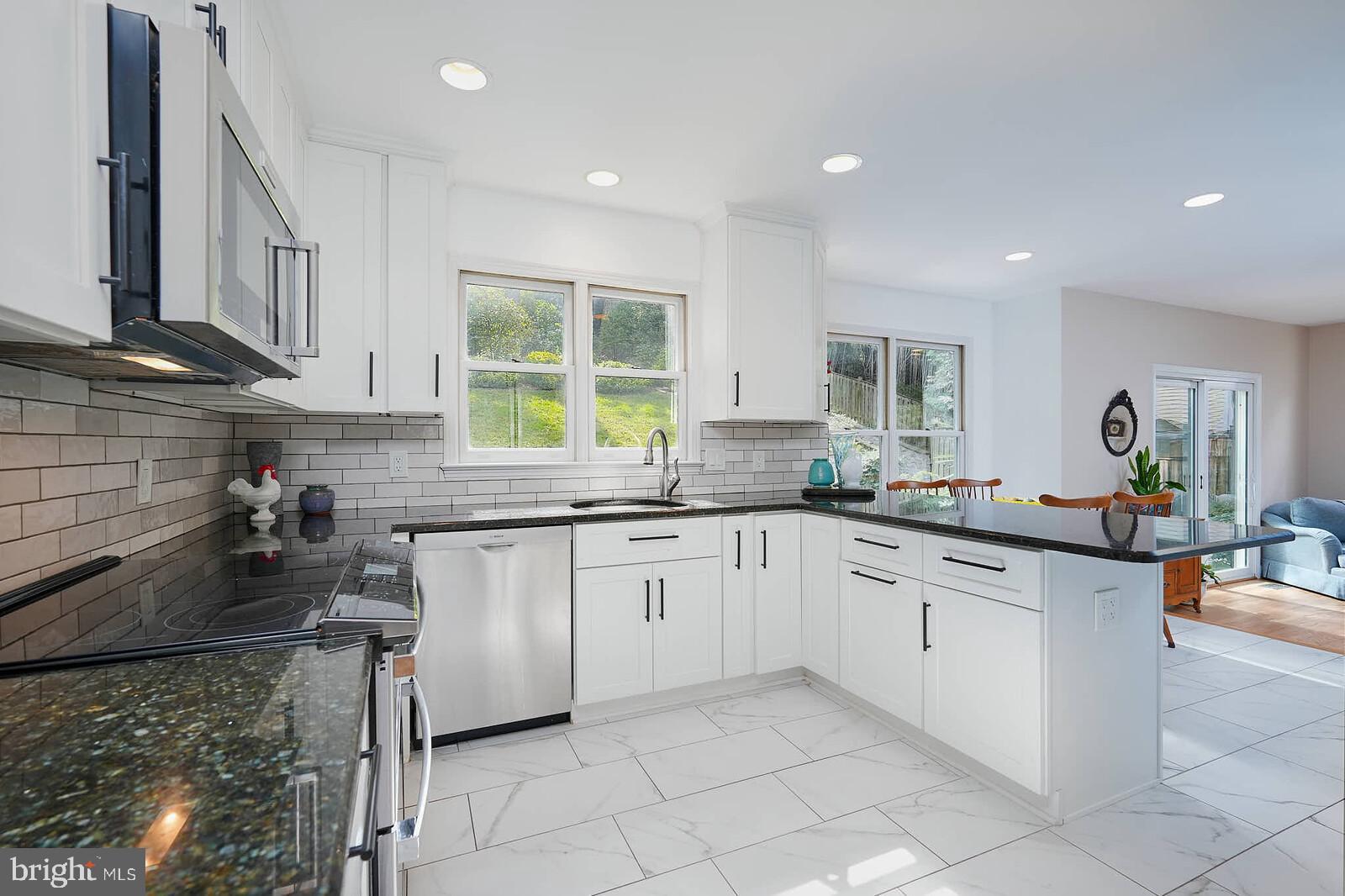 9505 Columbia Boulevard Silver Spring, MD 20910 - Photo 2 of 55 a kitchen with sink cabinets and window