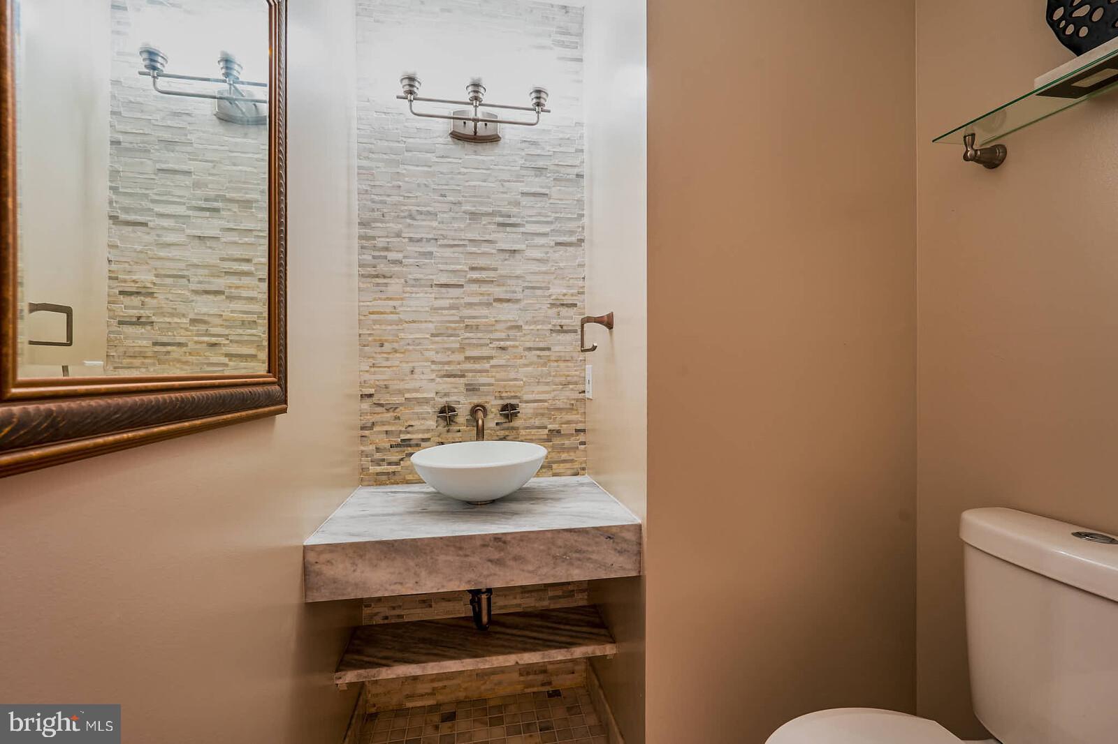 9505 Columbia Boulevard Silver Spring, MD 20910 - Photo 21 of 55 a bathroom with a toilet a sink and a window