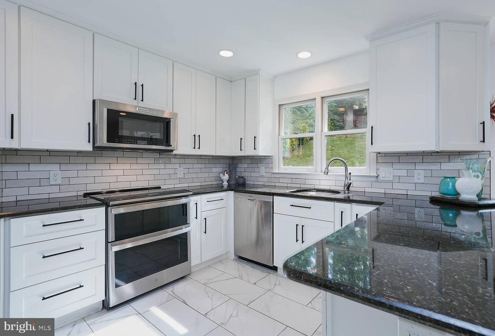 9505 Columbia Boulevard Silver Spring, MD 20910 - Photo 3 of 55 a kitchen with cabinets appliances a sink and a counter top space