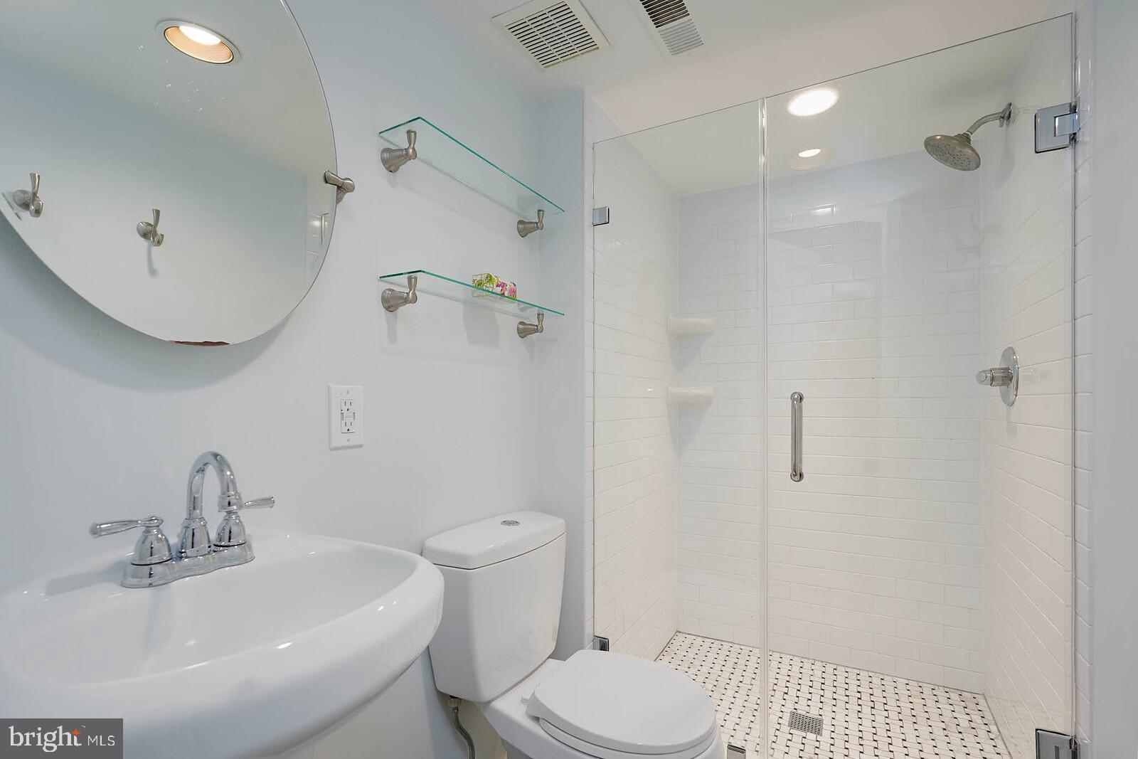 9505 Columbia Boulevard Silver Spring, MD 20910 - Photo 33 of 55 a bathroom with a sink toilet and shower
