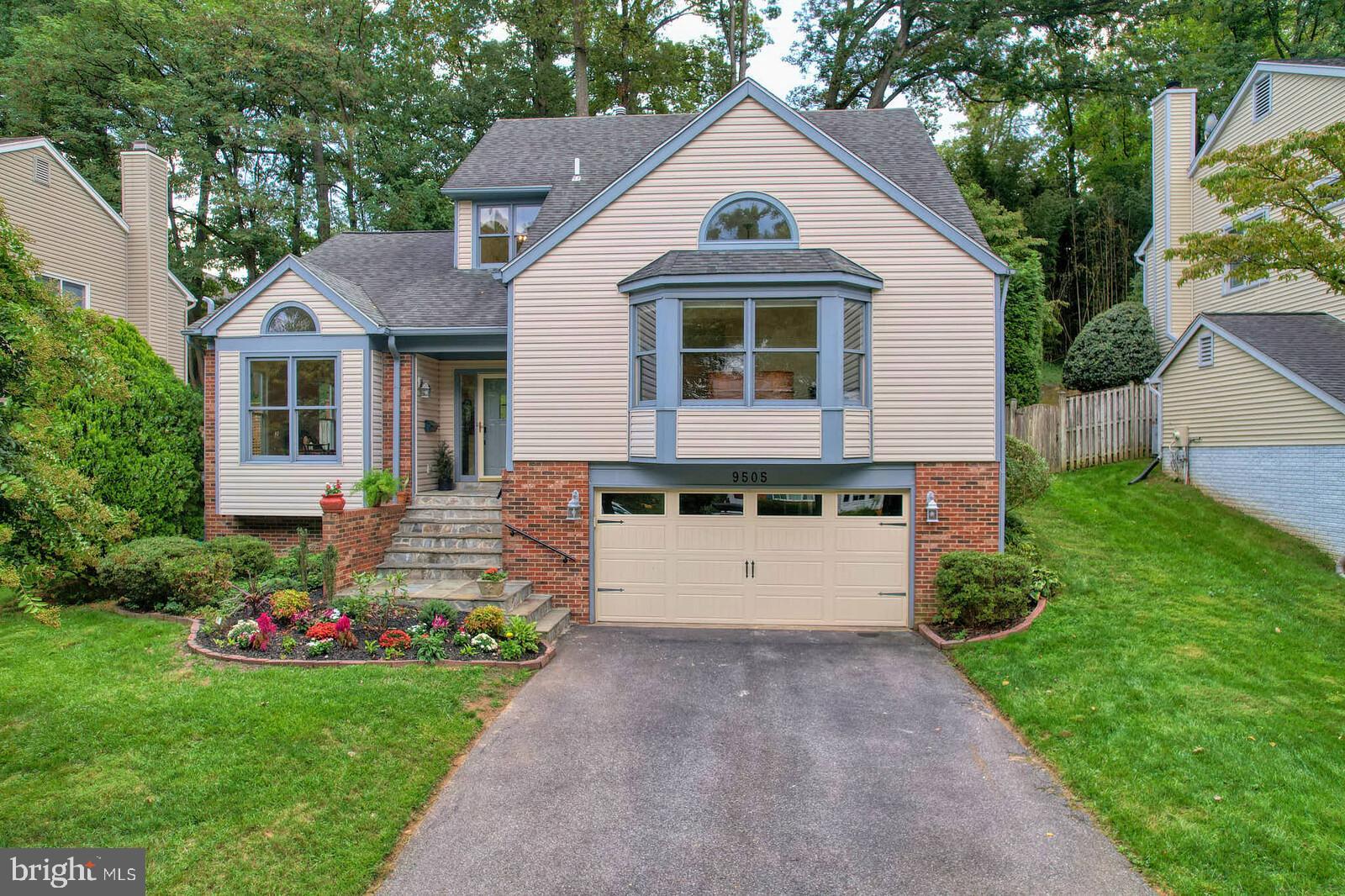 9505 Columbia Boulevard Silver Spring, MD 20910 - Photo 48 of 55 a front view of a house with a yard and garage