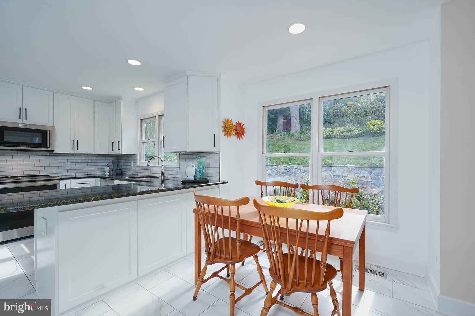 9505 Columbia Boulevard Silver Spring, MD 20910 - Photo 5 of 55 a kitchen with a table chairs sink and cabinets
