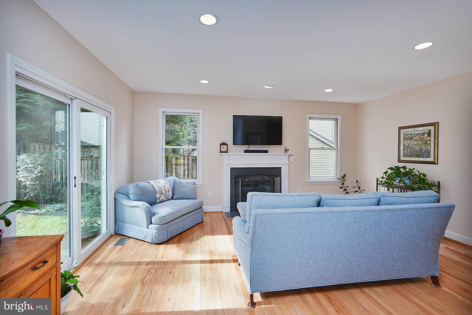 9505 Columbia Boulevard Silver Spring, MD 20910 - Photo 7 of 55 a living room with furniture a flat screen tv and a fireplace