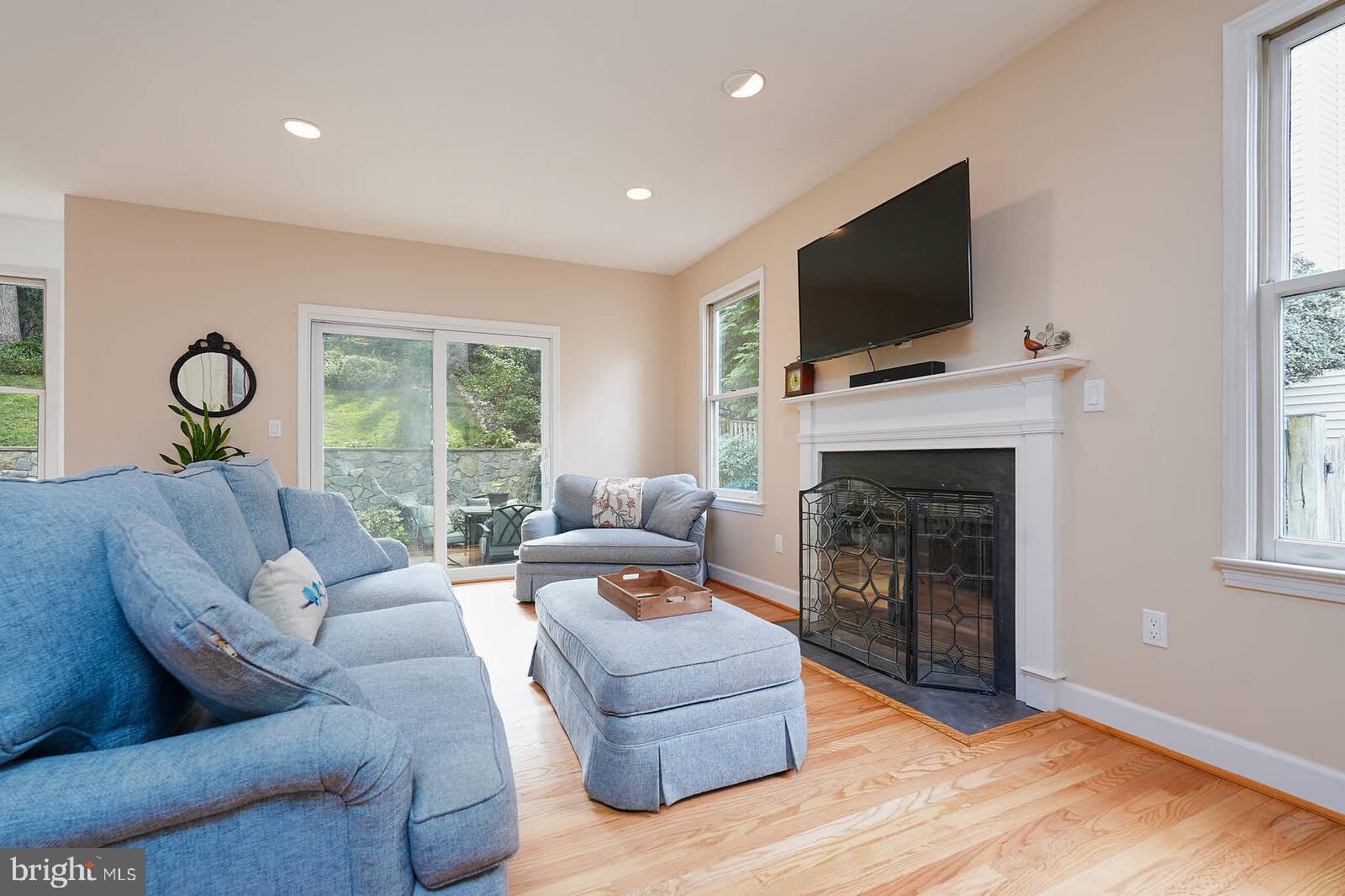 9505 Columbia Boulevard Silver Spring, MD 20910 - Photo 9 of 55 a living room with furniture a flat screen tv and a fireplace
