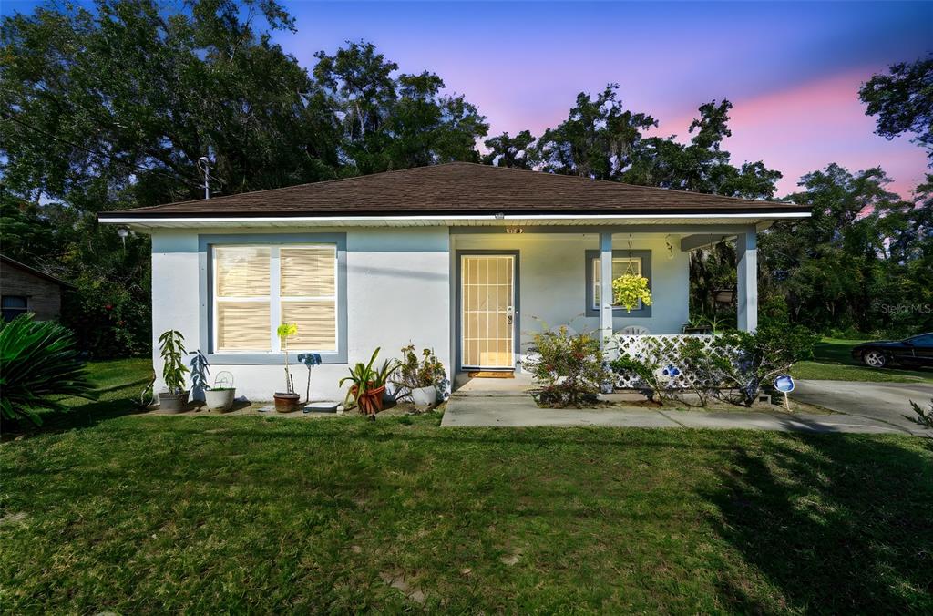 a front view of a house with a garden