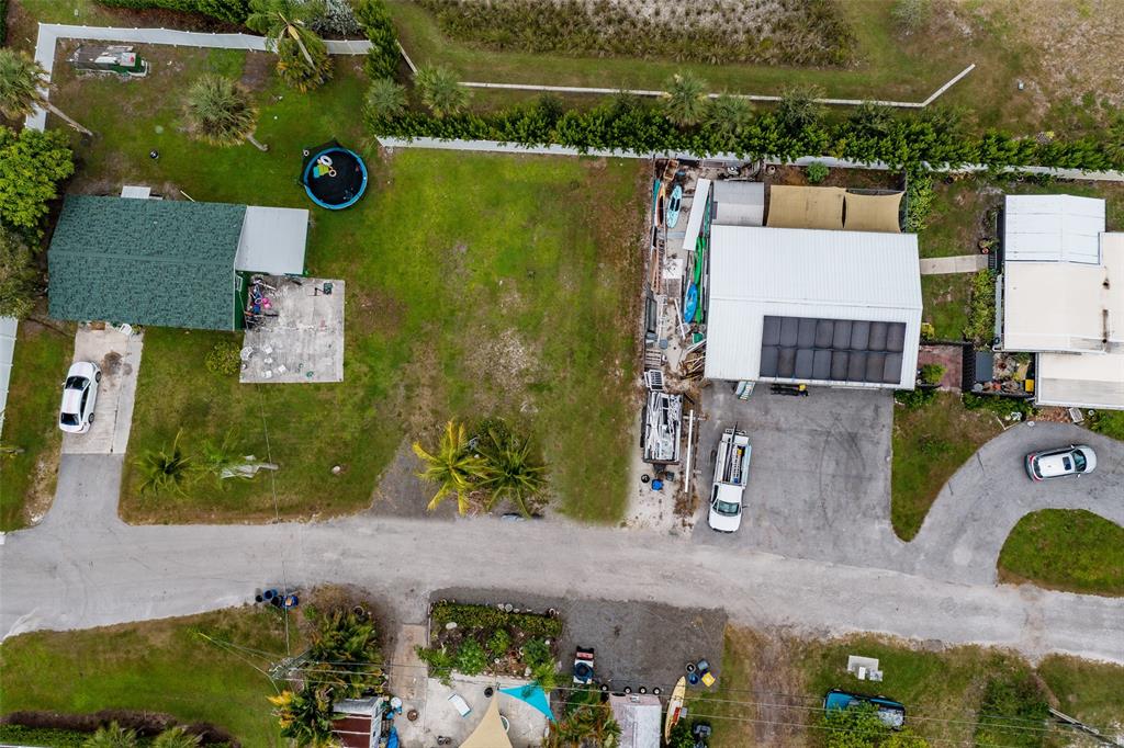 5754 Southeast Green Lane Stuart, FL 34997 - Photo 16 of 16 an aerial view of residential houses with outdoor space and parking