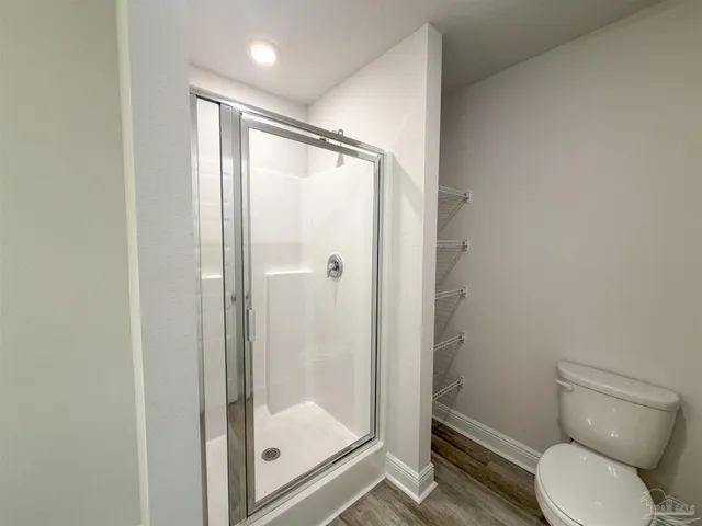 a bathroom with a glass shower door