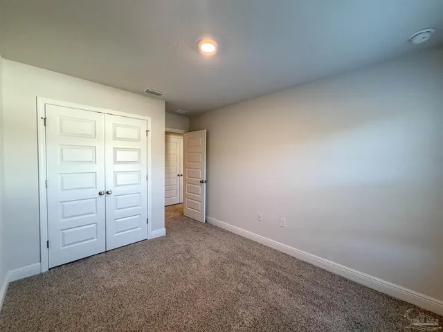 an empty room with closet area