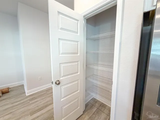a view of walk in closet with empty racks