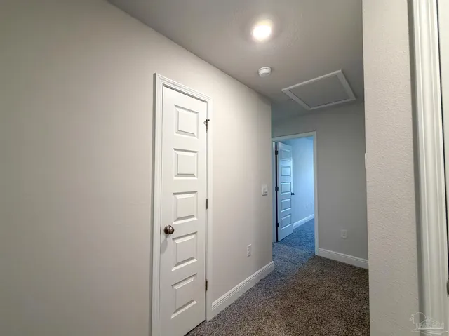 an empty room with closet and mirror
